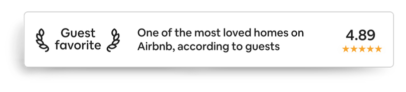 A white sign that says guest favorite one of the most loved homes on airbnb according to guests