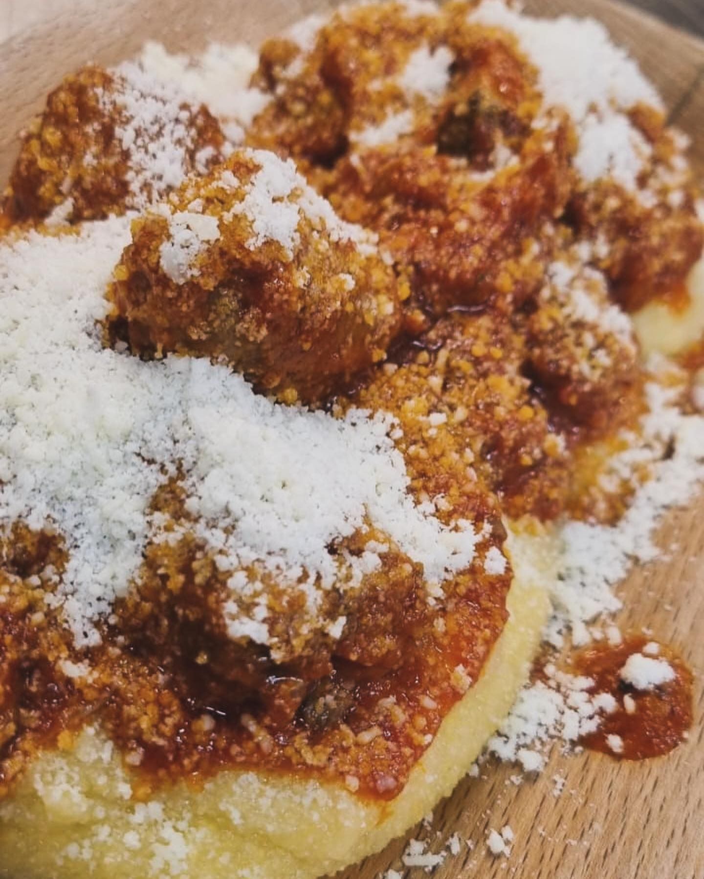Pizza condita con salsa di pomodoro, carne sbriciolata e un generoso strato di formaggio grattugiato.