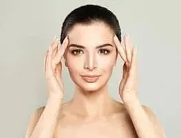 Fair-Skinned Woman Holding Her Face – Danvers, MA – North Shore Facial Plastic Surgery