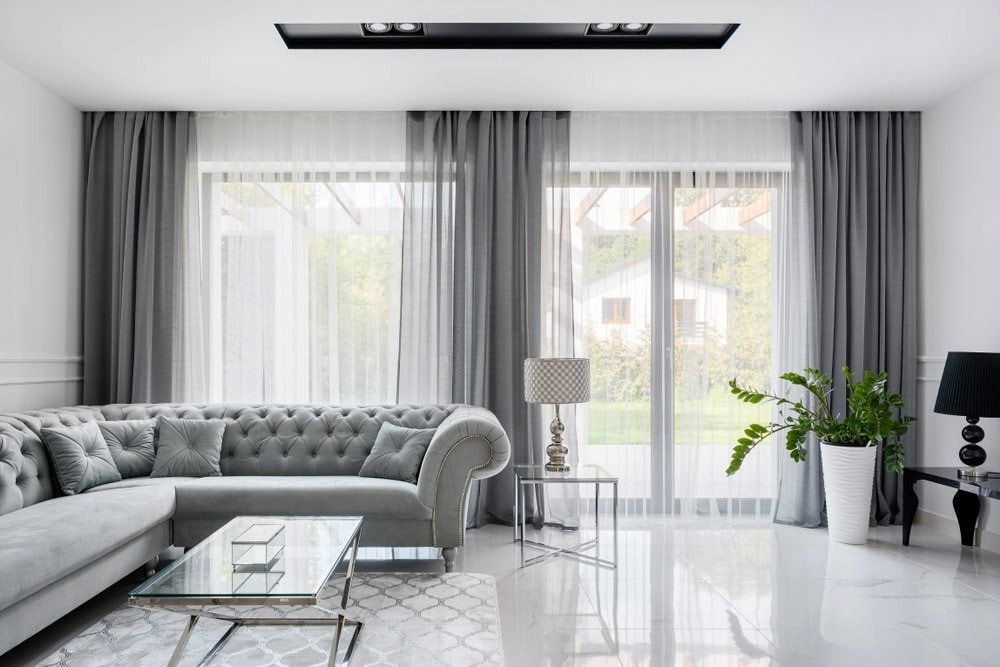A Living Room With a Couch, Coffee Table, and Curtains — Shields Painting & Decorating in Narrandera, NSW
