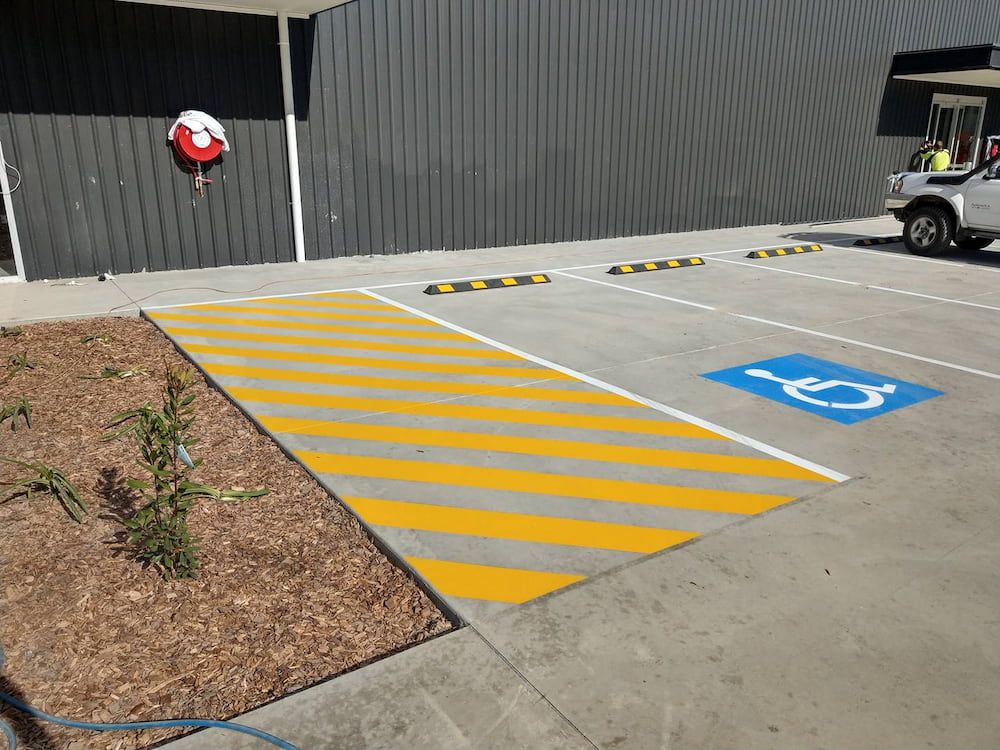 A Handicapped Parking Spot is Painted in a Parking Lot — Shields Painting & Decorating in Gundagai, NSW