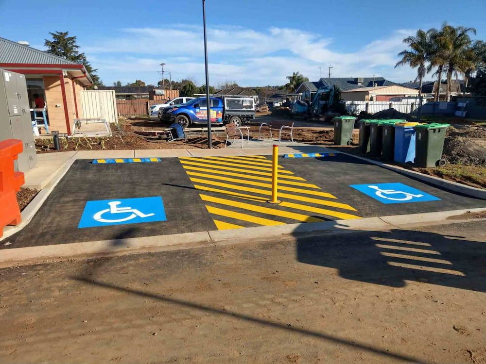 A Handicapped Parking Spot is Painted on the Side of the Road — Shields Painting & Decorating in Narrandera, NSW