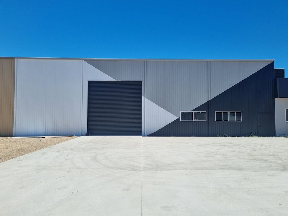 A Large Building With a Concrete Driveway in Front of It — Shields Painting & Decorating in Wagga Wagga, NSW