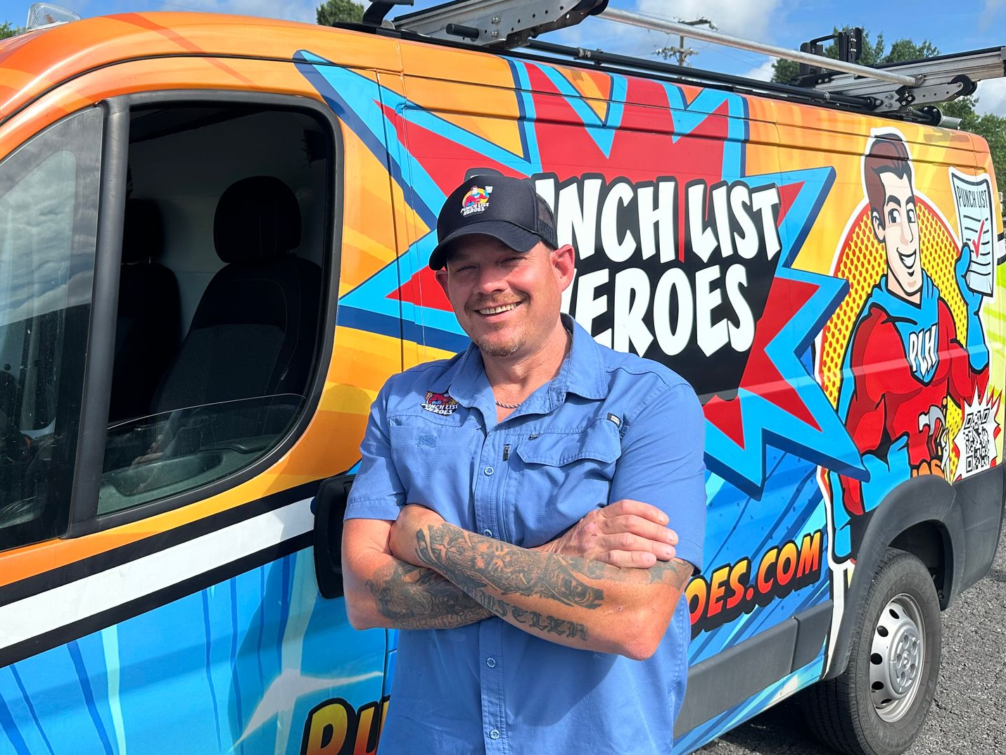A young man is standing in front of a colorful van. A young man is standing in front of a colorful van.