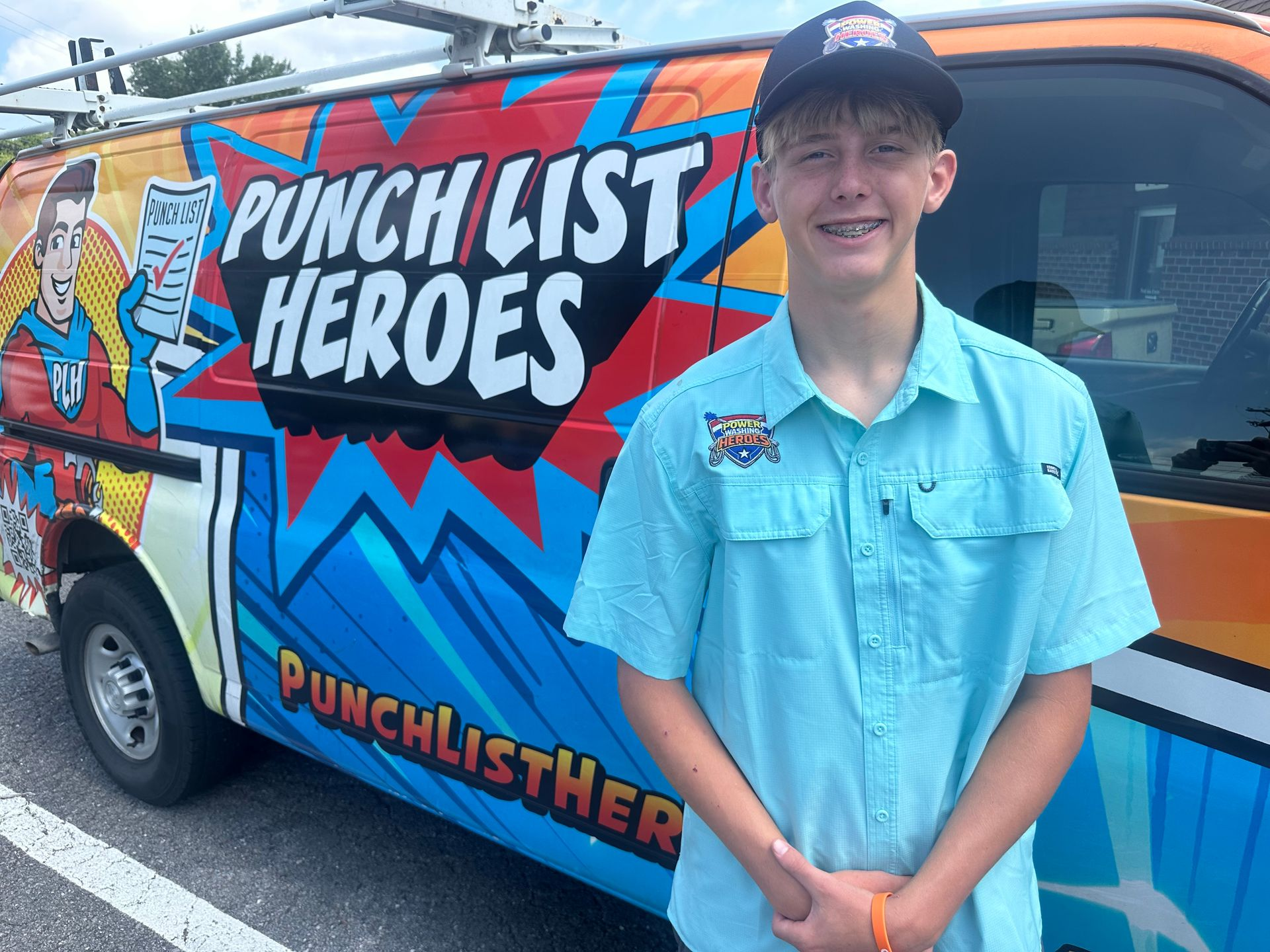 A young man is standing in front of a colorful van. A young man is standing in front of a colorful van.