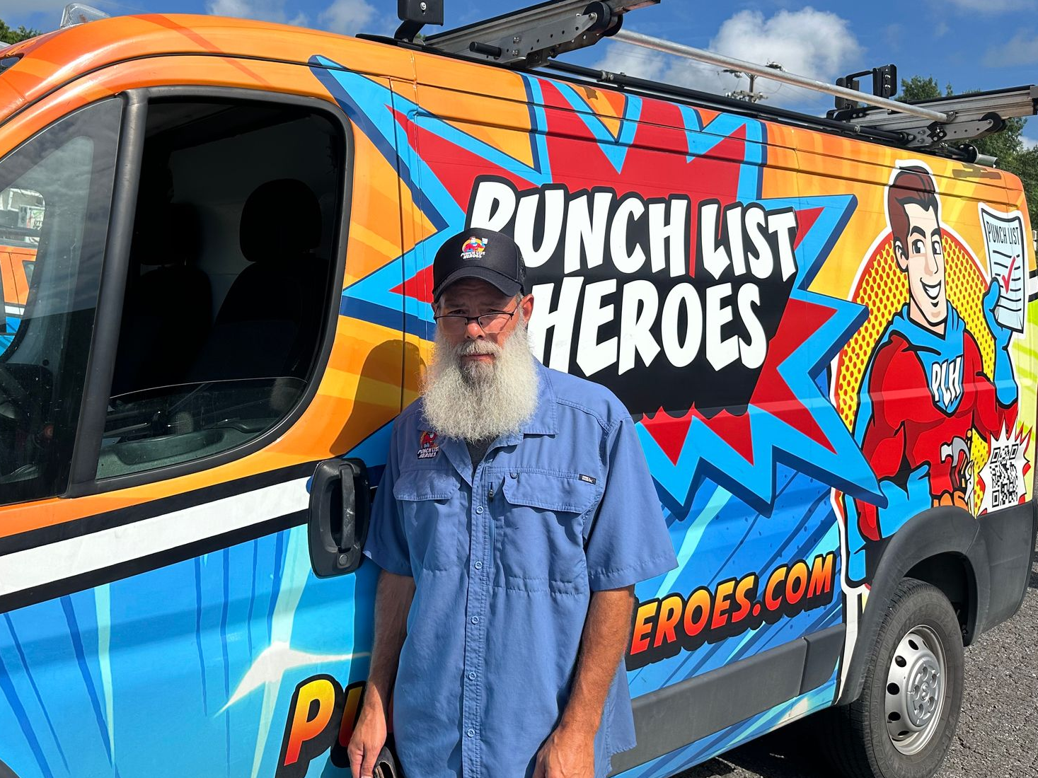A young man is standing in front of a colorful van. A young man is standing in front of a colorful van.