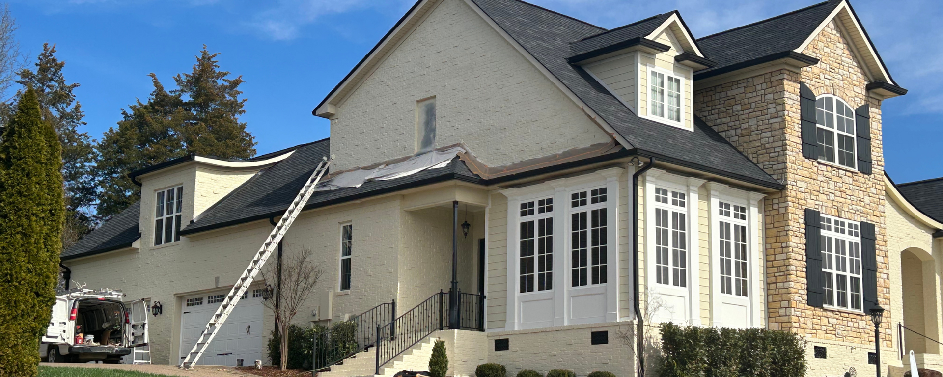 A brick house with a porch with shades on it. A brick house with a porch with shades on it.