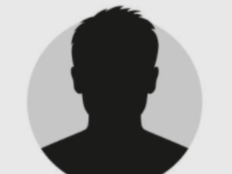 A young man is standing in front of a colorful van. A young man is standing in front of a colorful van.