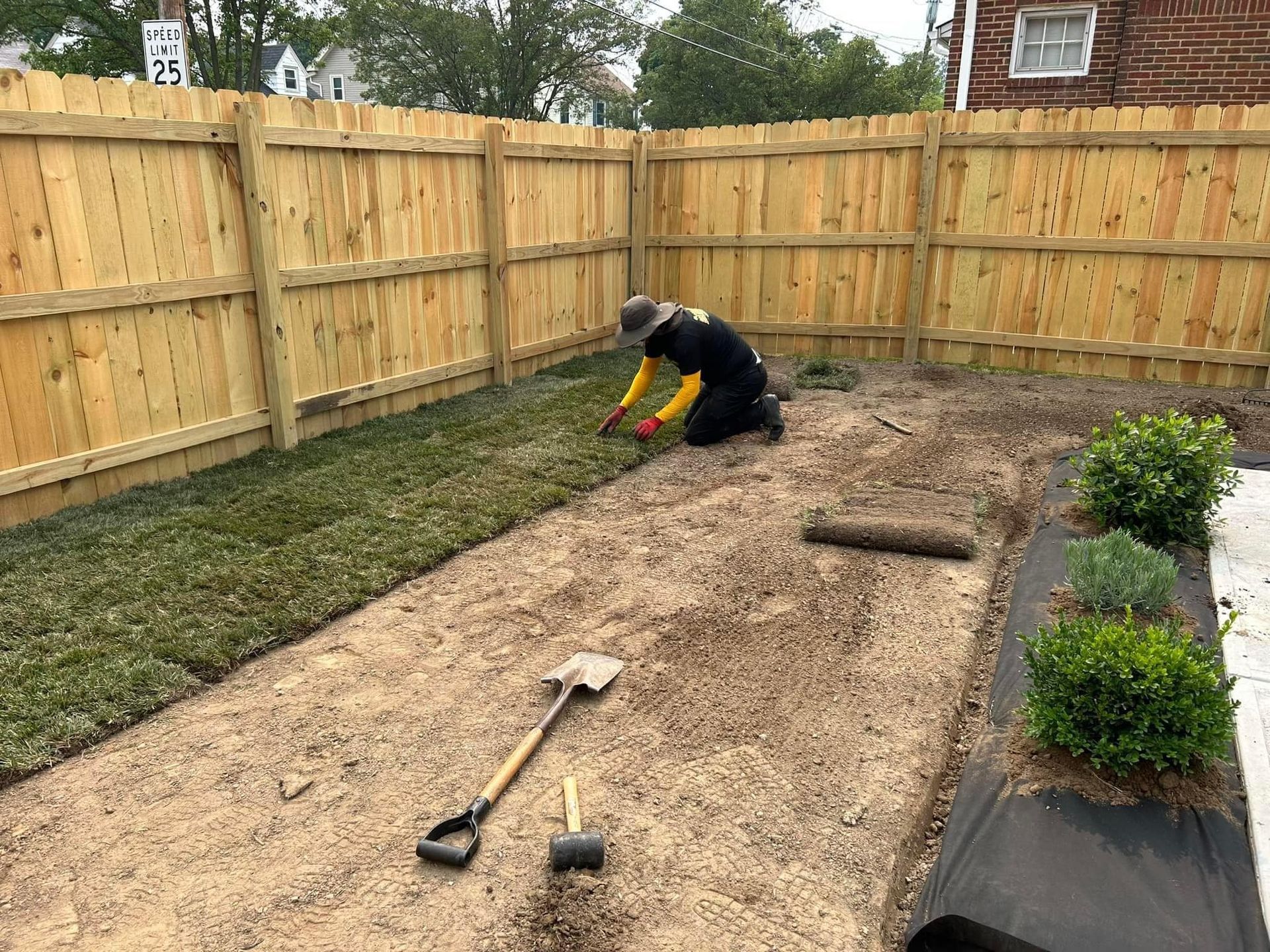 Laying Grass Sods at Backyard — Northeast OH — Believeland Landscaping and Snow Removal