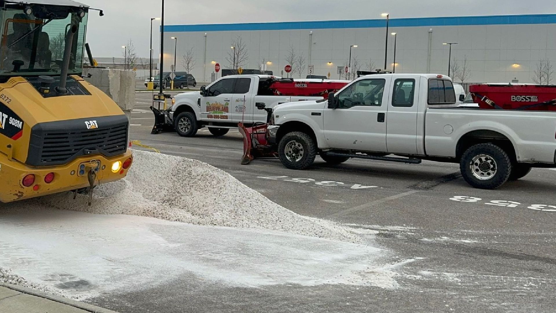 Man with Snow Shovel Cleans Sidewalk — Northeast OH — Believeland Landscaping and Snow Removal
