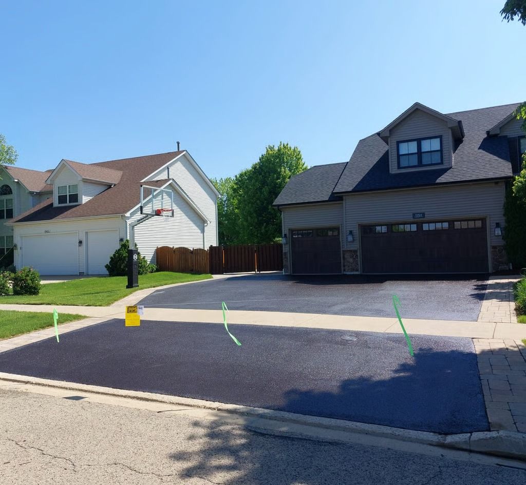 Suburban street with two houses, a driveway, and bright green lines marked on the pavement