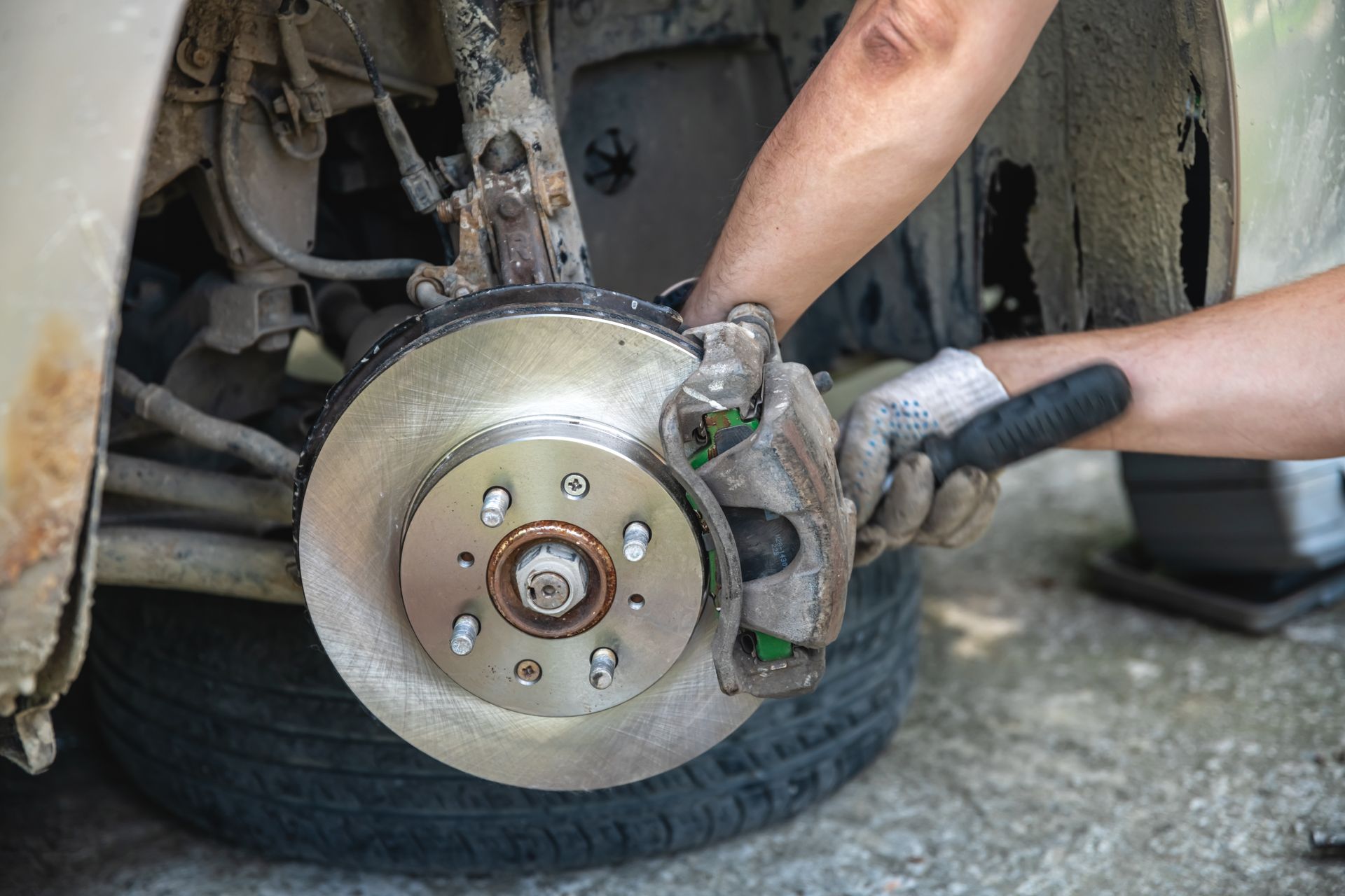 mechanic changing brake pad