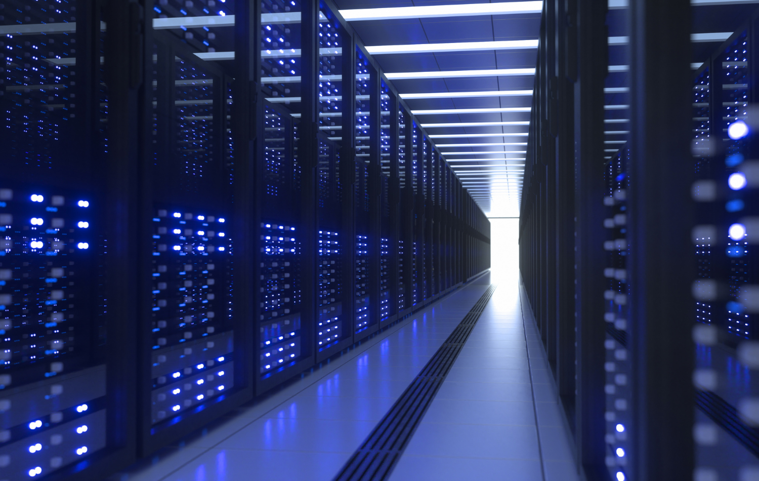 Blue-lit server racks in a narrow data center aisle with bright lights at the far end