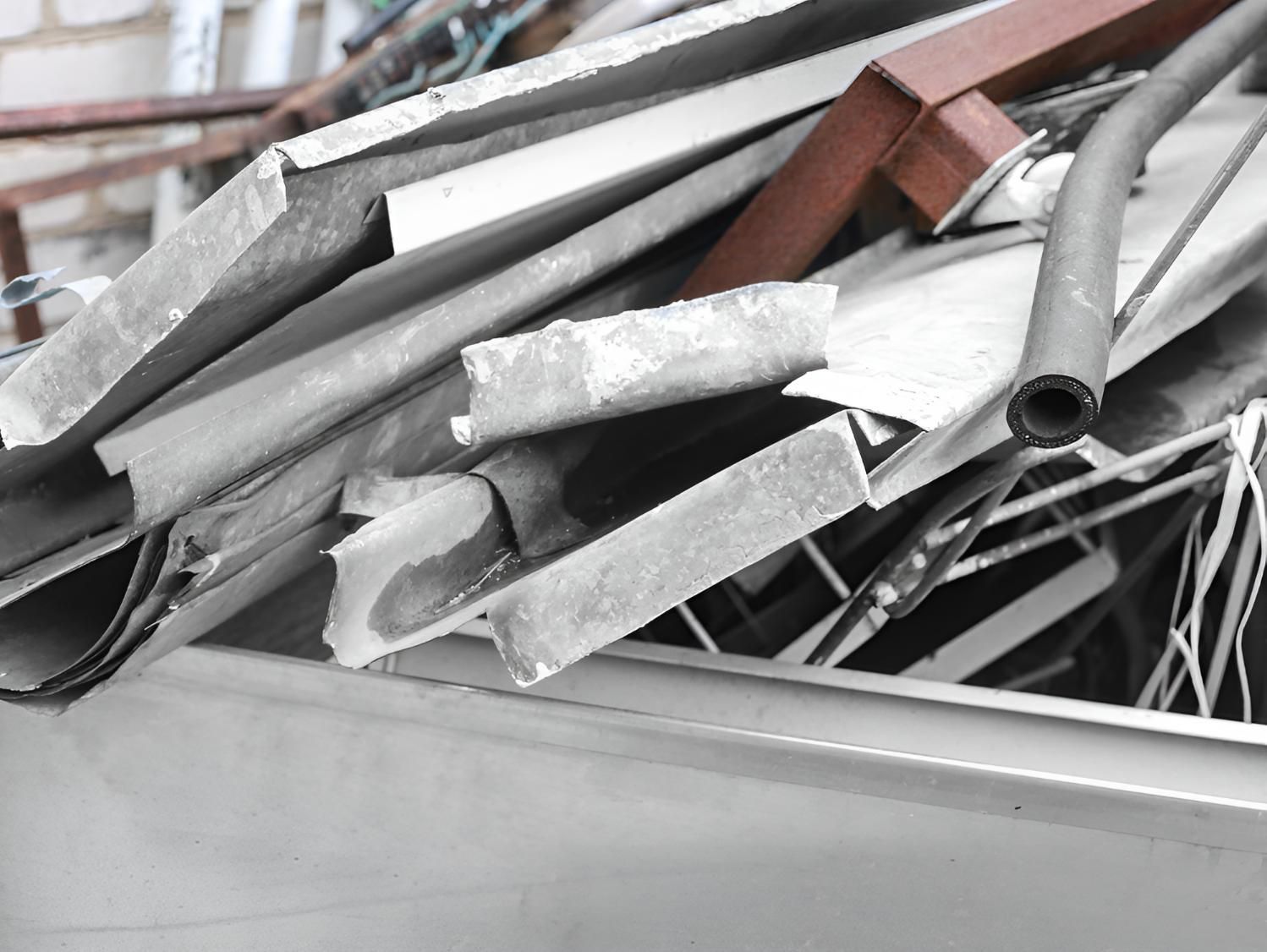 Pile of Scrap Metal is Sitting in a Bin — Maryborough Recycling in Mount Perry, QLD