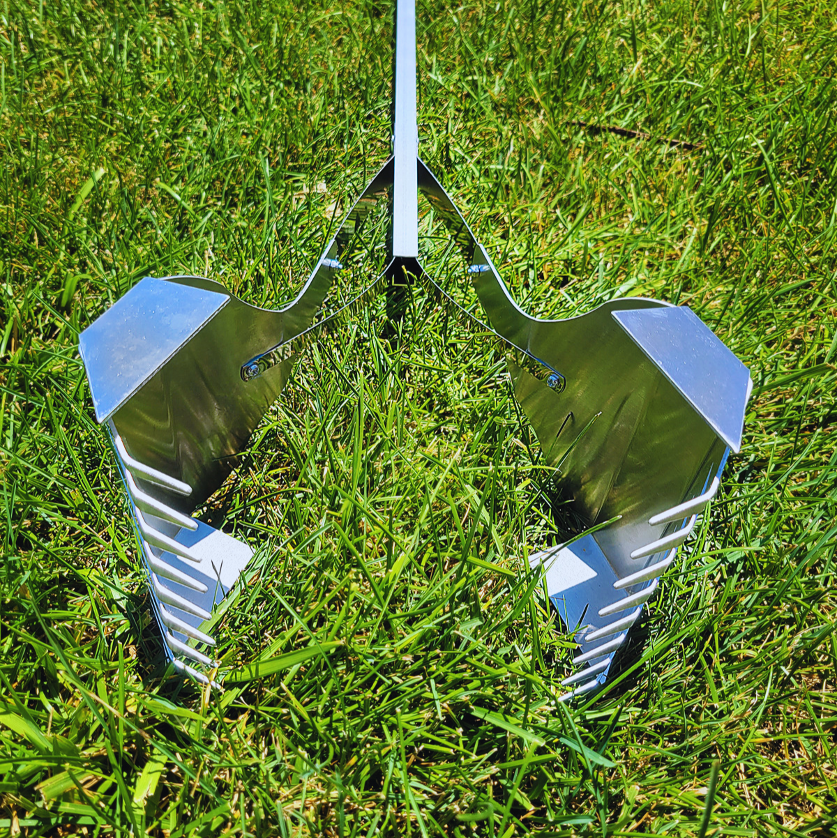 A metal object is sitting on top of a lush green field