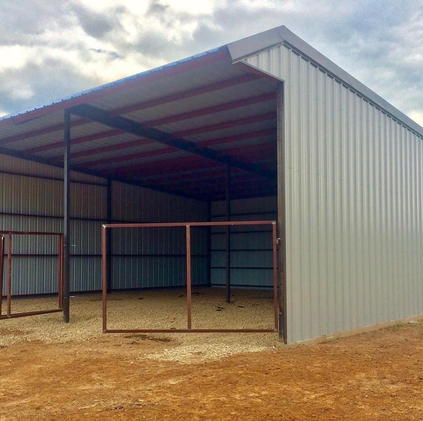 A large metal building with a red roof