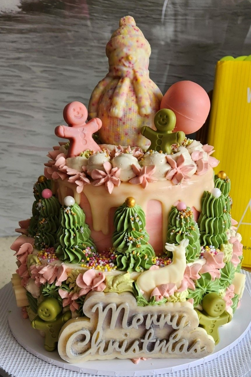 Christmas-themed cake with gingerbread men, trees, and 