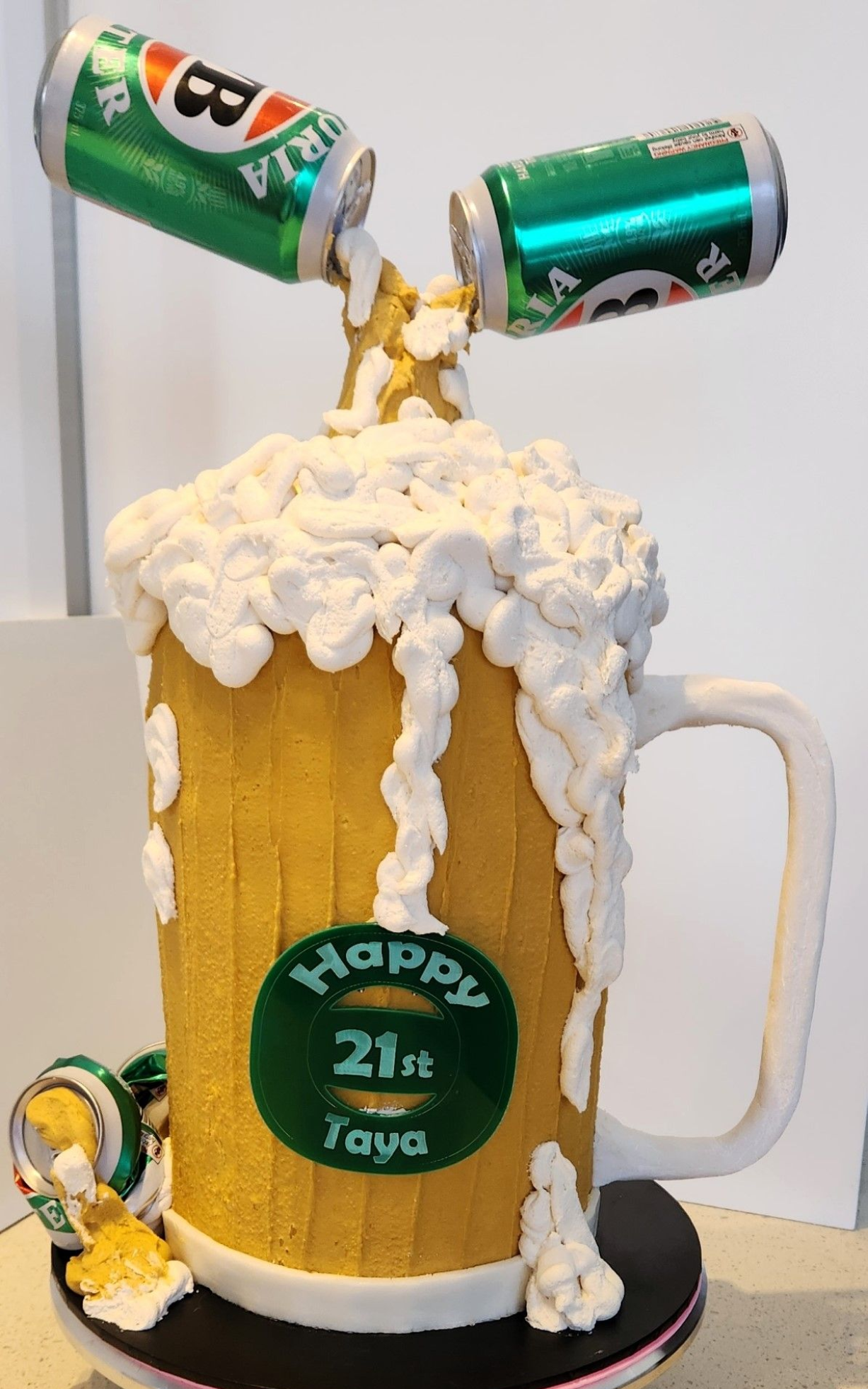 Beer mug cake with dripping foam, beer cans, and 