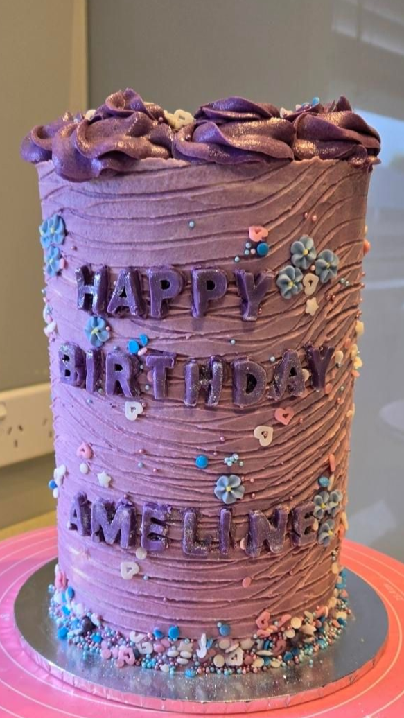 Purple birthday cake with textured frosting, 