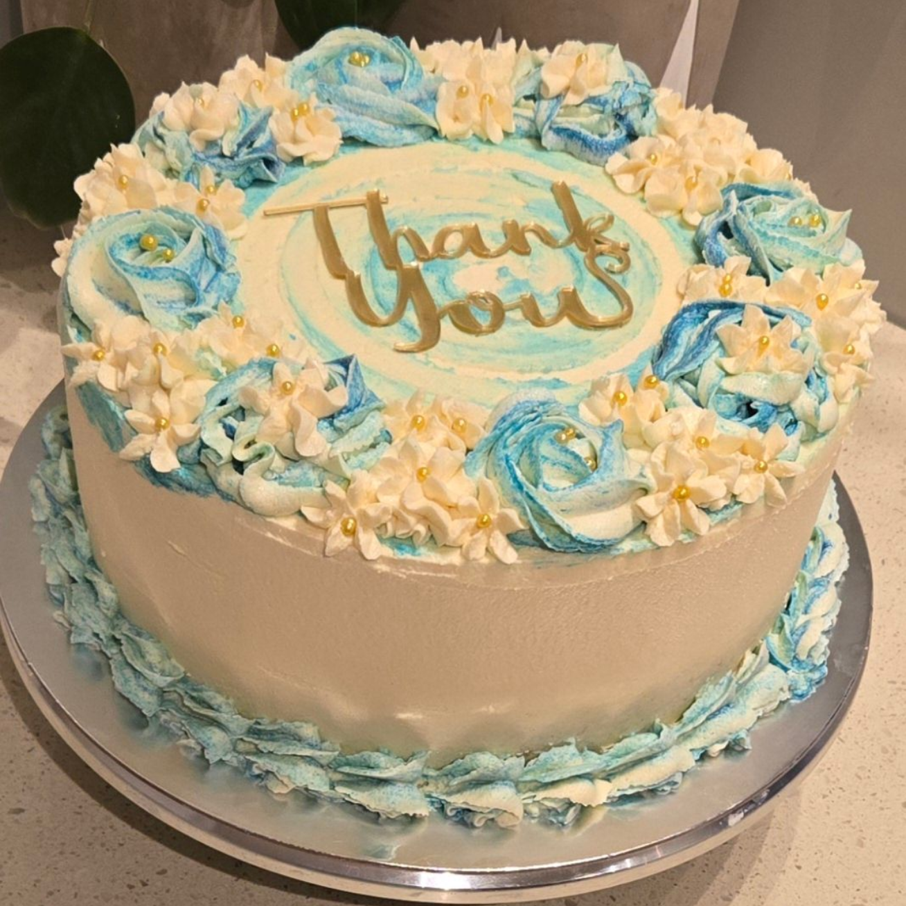 Cake decorated with blue and white frosting and 