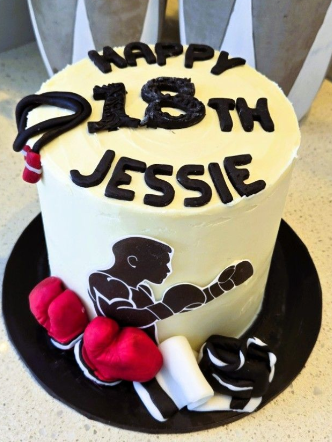 Boxing-themed 18th birthday cake with boxer silhouette, boxing gloves, and 