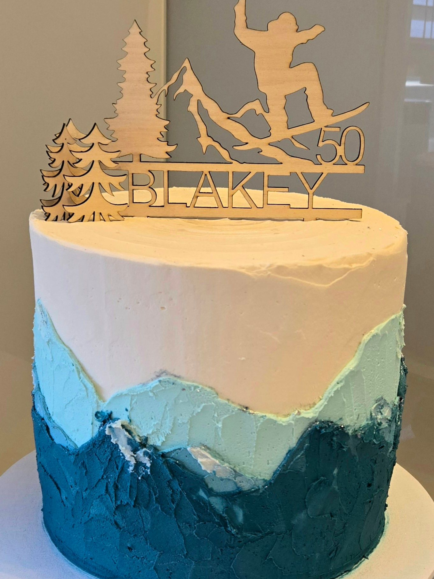 Cake with mountain design and snowboarder cake topper for 