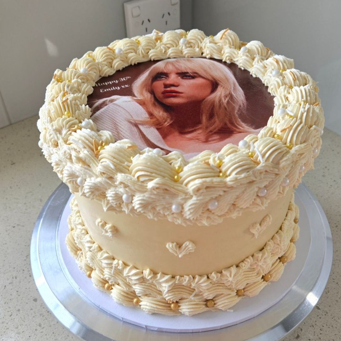 Cake decorated with a Billie Eilish edible image and buttercream frosting.