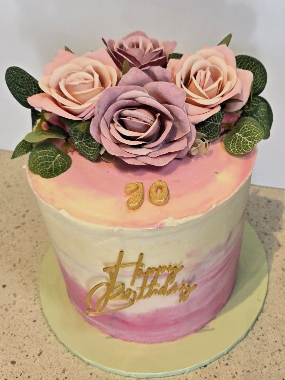 Cake decorated with pink and purple flowers, 