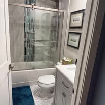 Bathroom remodel detail showing waterproof shower tile and bench installation.