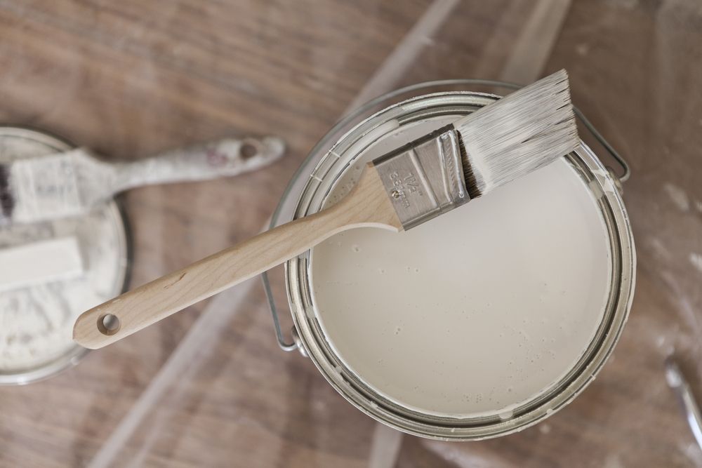Paint Can With a Paint Brush Resting on It — Keppel Coatings in Pacific Heights, QLD