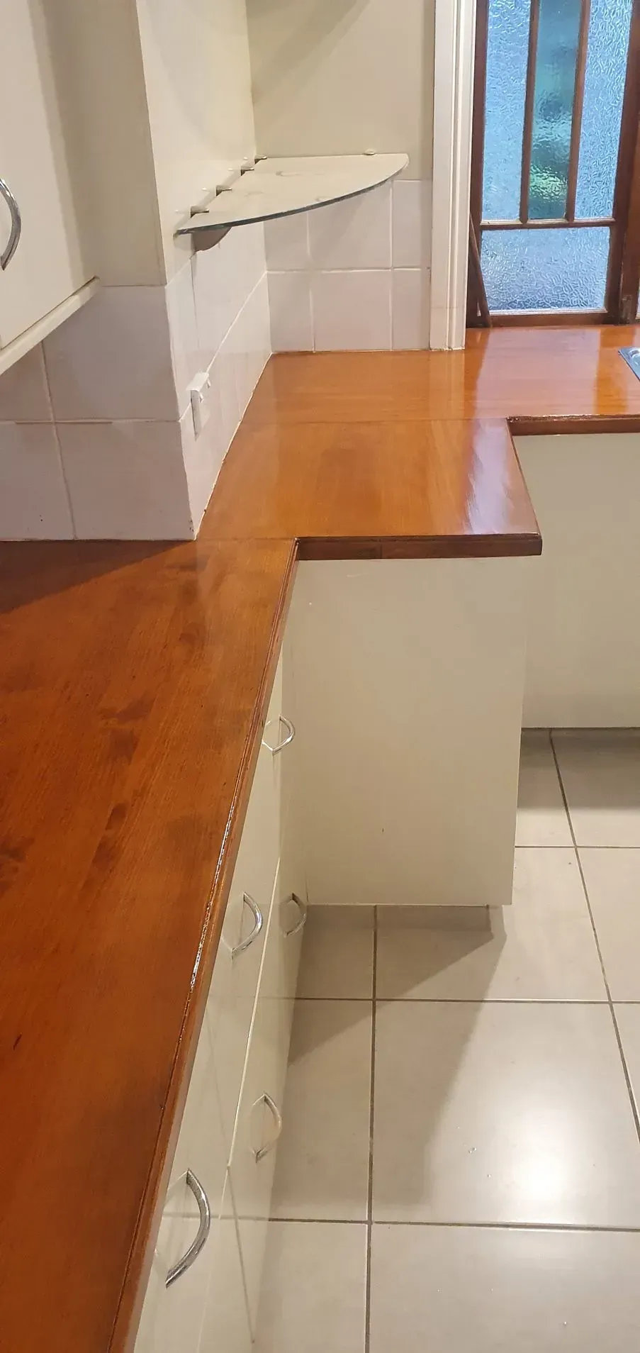 Kitchen With Wooden Countertops and White Cabinets — Keppel Coatings in Pacific Heights, QLD