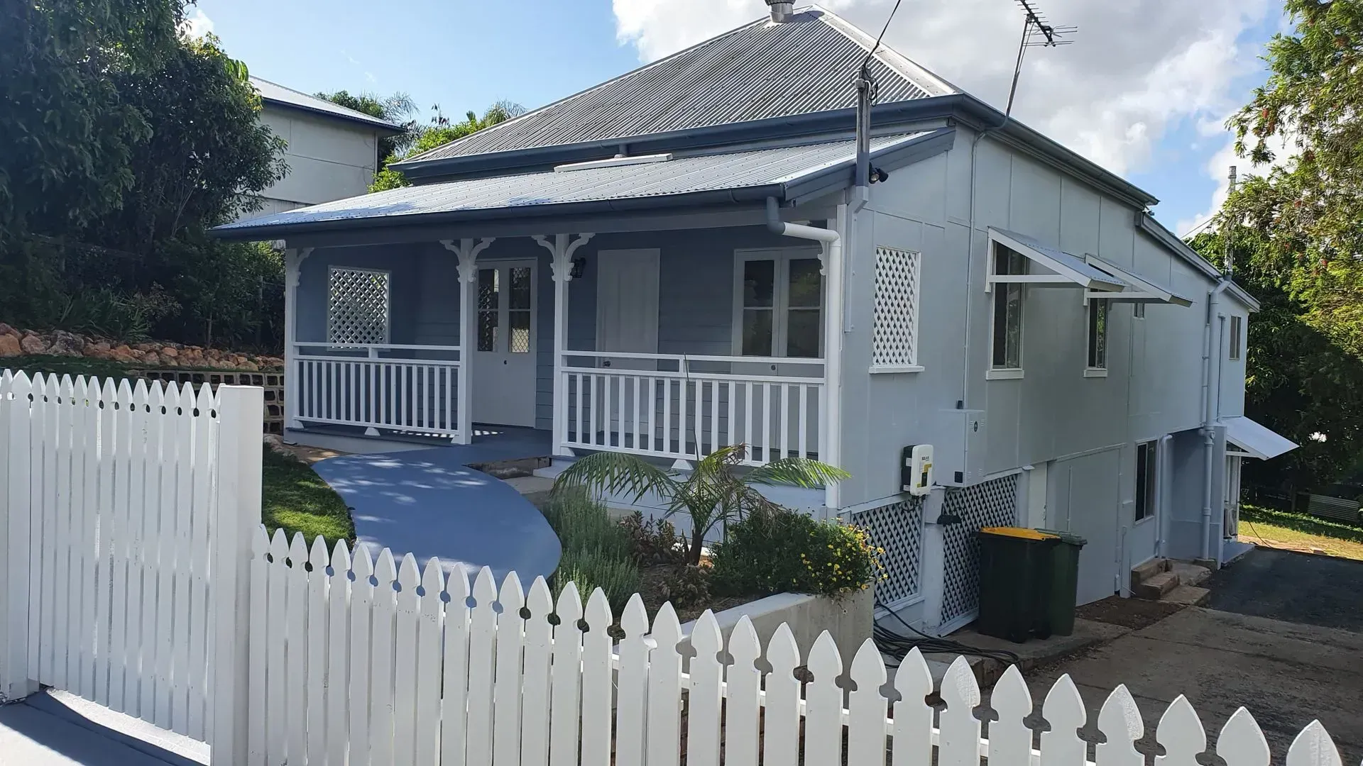 Light Blue House With White Picket Fence and Porch — Keppel Coatings in Pacific Heights, QLD