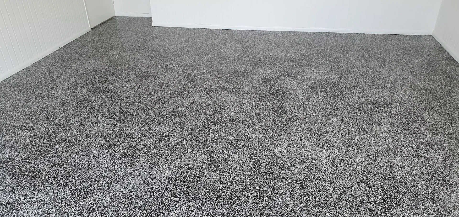 Gray Speckled Flooring in a Room With White Walls — Keppel Coatings in Pacific Heights, QLD