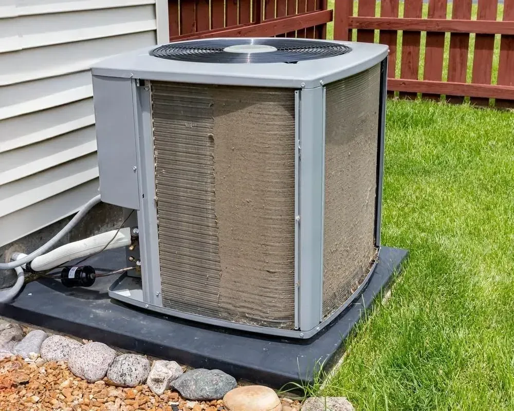 Indoor heat pump unit with silver ductwork installed in a bright home interior