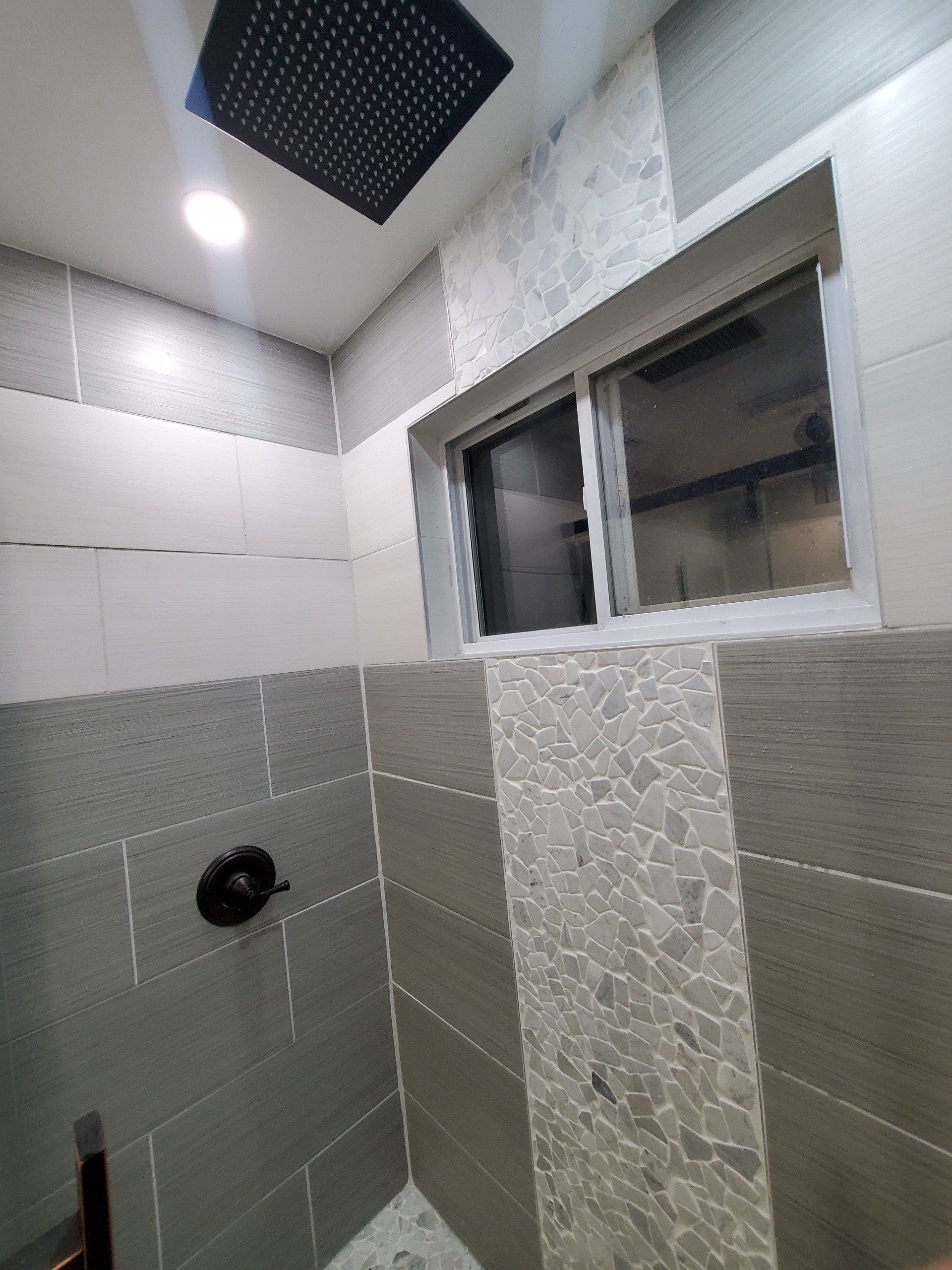white tiles with an accent in a bathroom shower