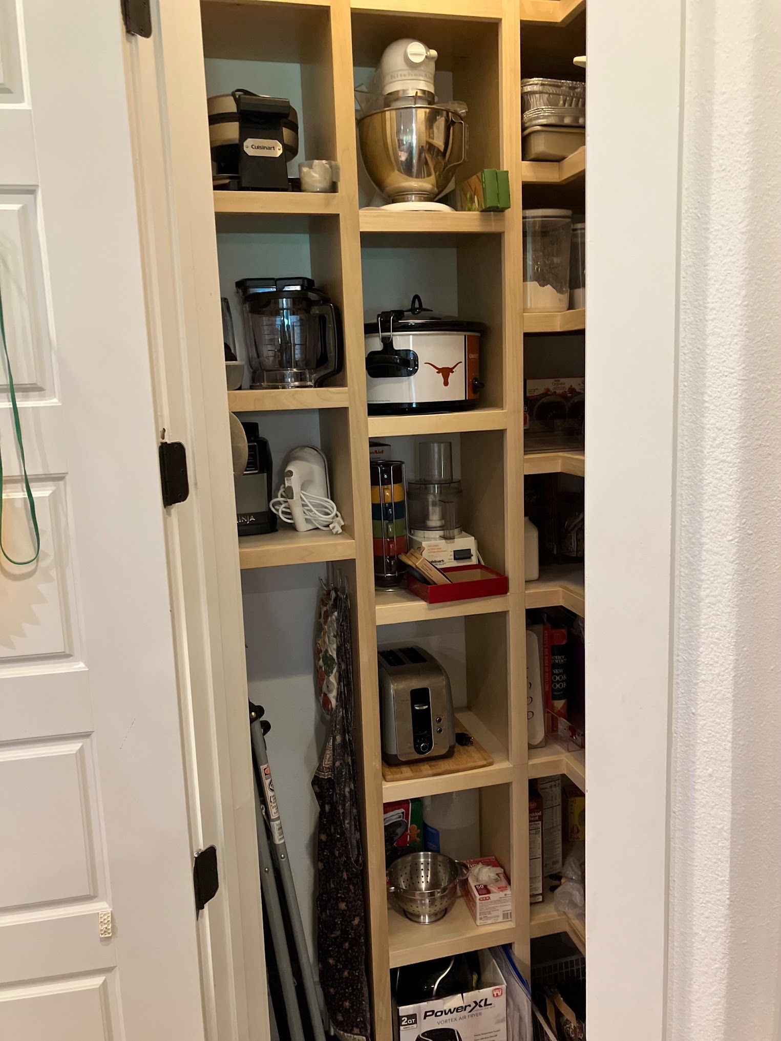 A pantry filled with lots of food items and appliances.
