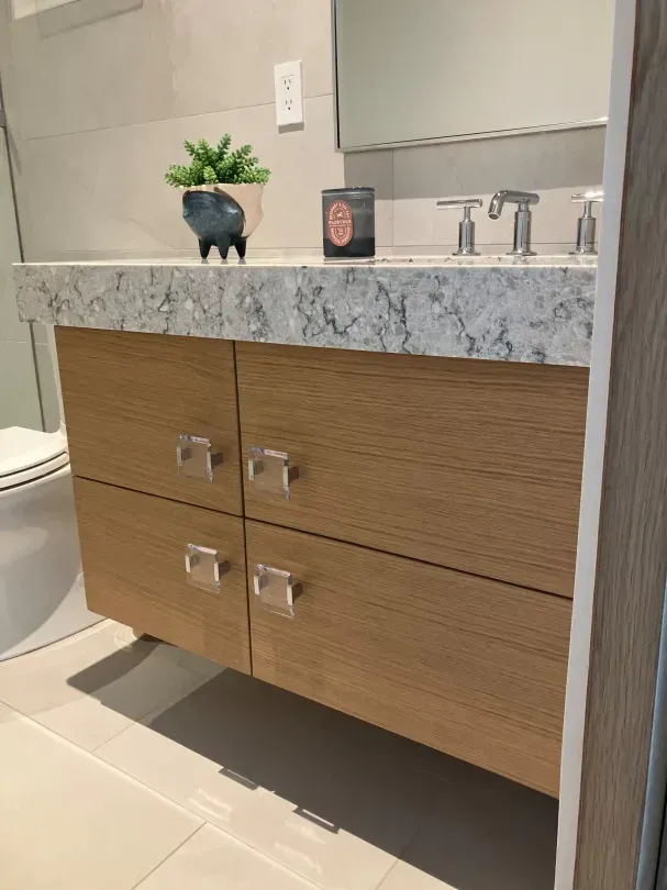 A bathroom with a sink , toilet and mirror.