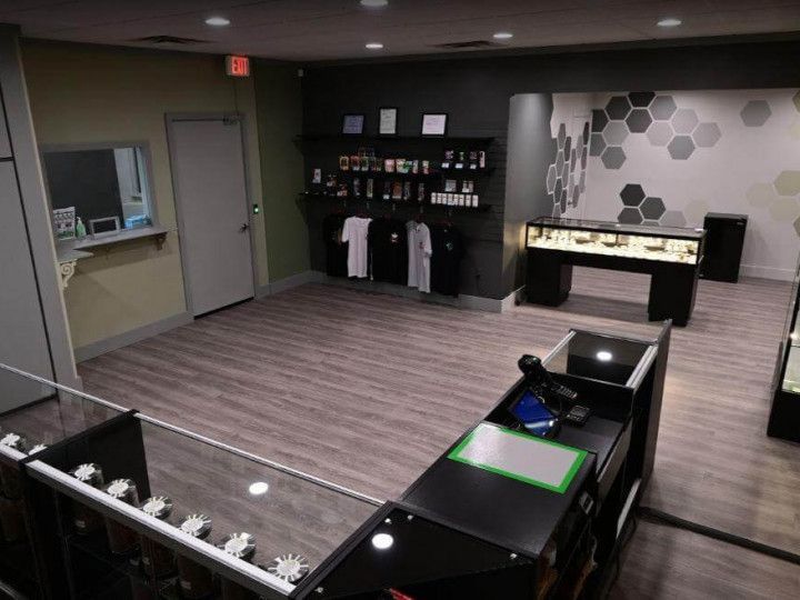 Modern hotel room with two beds, desk, wall TV, and patterned accent wall