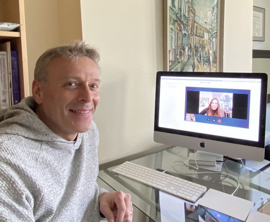 A man is sitting in front of an apple computer