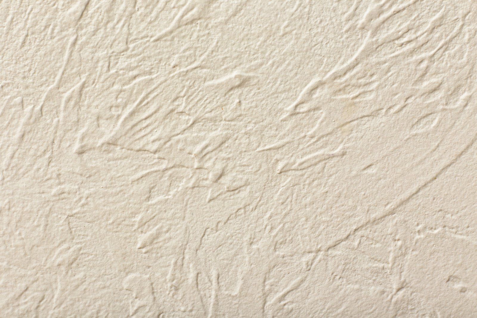 Sandy beach surface with textured patterns created by water movement.