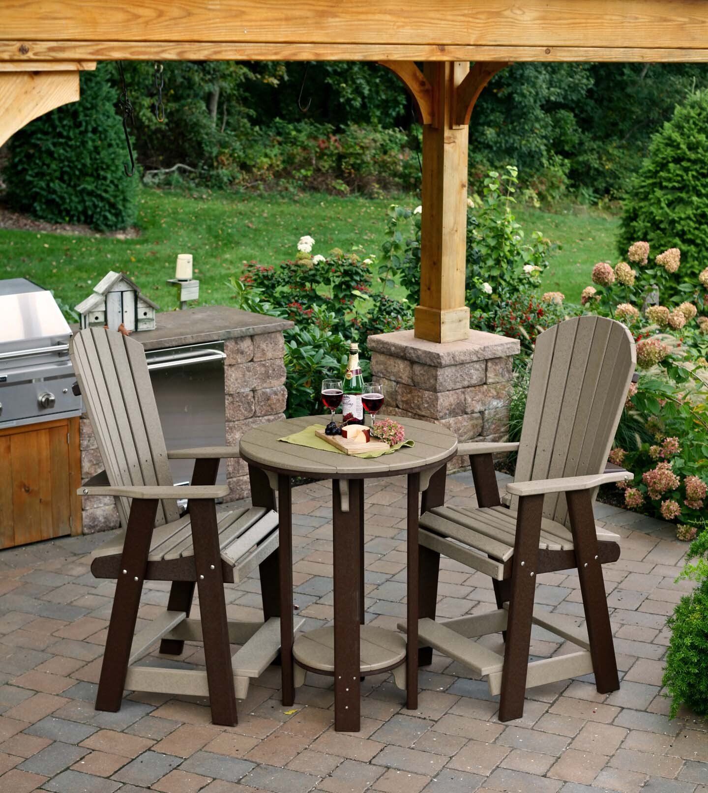 Two outdoor chairs and a table on a patio. The chairs are brown and tan.