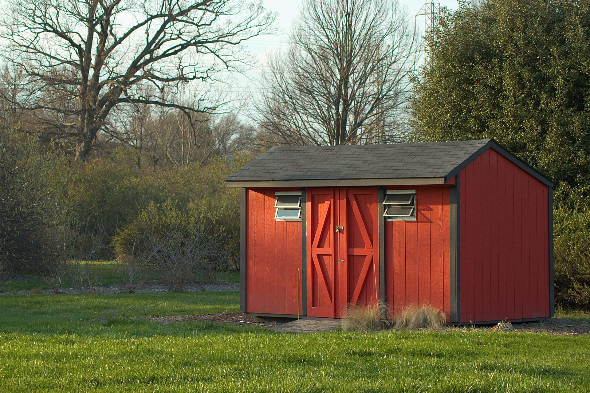 A red shed in a field l  Storage Shed Supplier in Concordville PA l Knot & Ore Outdoors 
