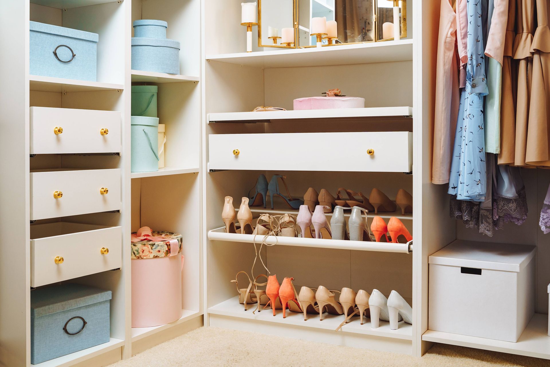 Large wardrobe with stylish women's clothing, shoes, accessories, and boxes.