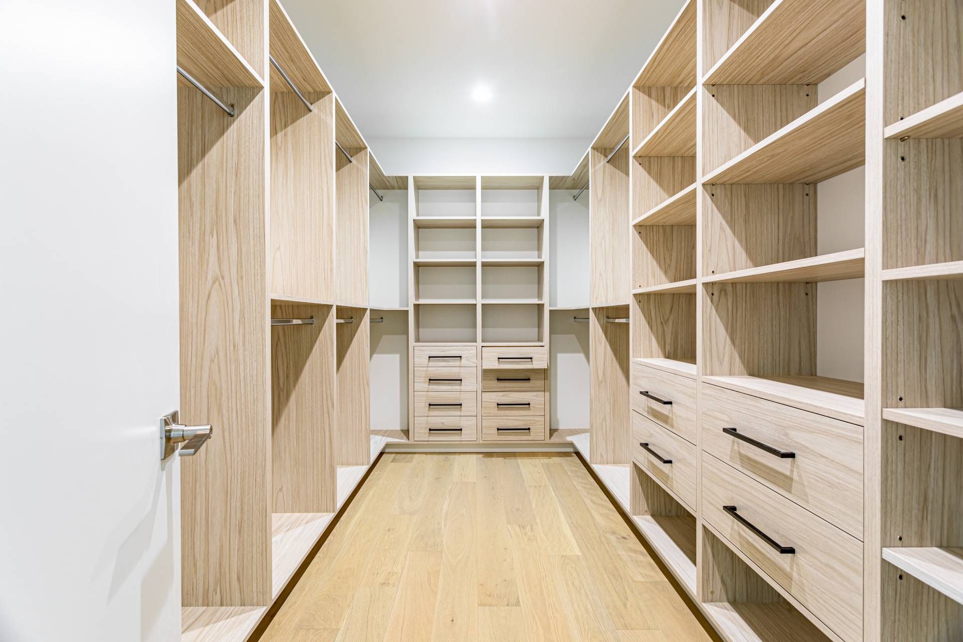 A custom closet with shelving and drawers at Voyager Closets & Organization