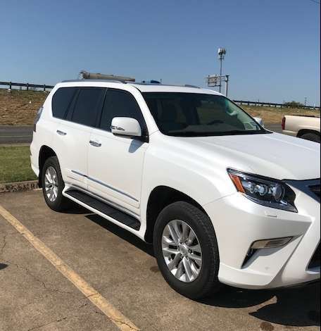 White Lexus SUV parked on asphalt.