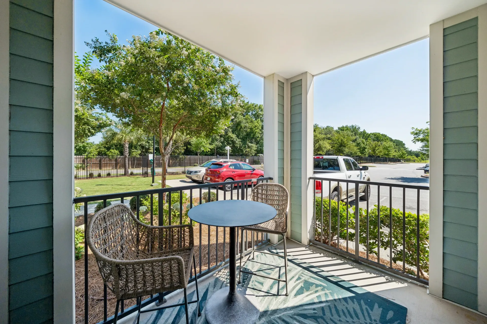 Balcony with seating and table overlooking parking lot at Atlantic on the Boulevard in North Charleston, SC.
