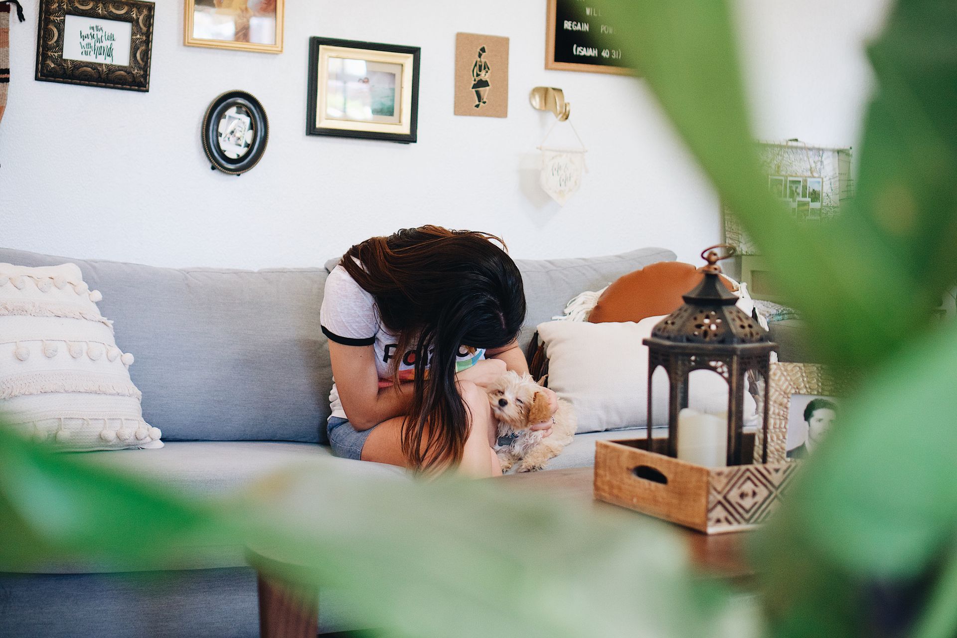 Woman with pet puppy at home.