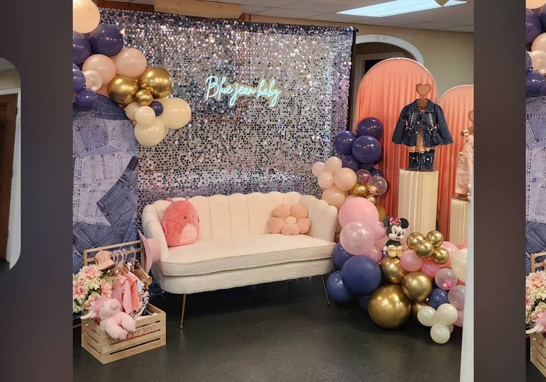 Pink-and-gold party backdrop with a white couch, balloons, and a sequin wall display
