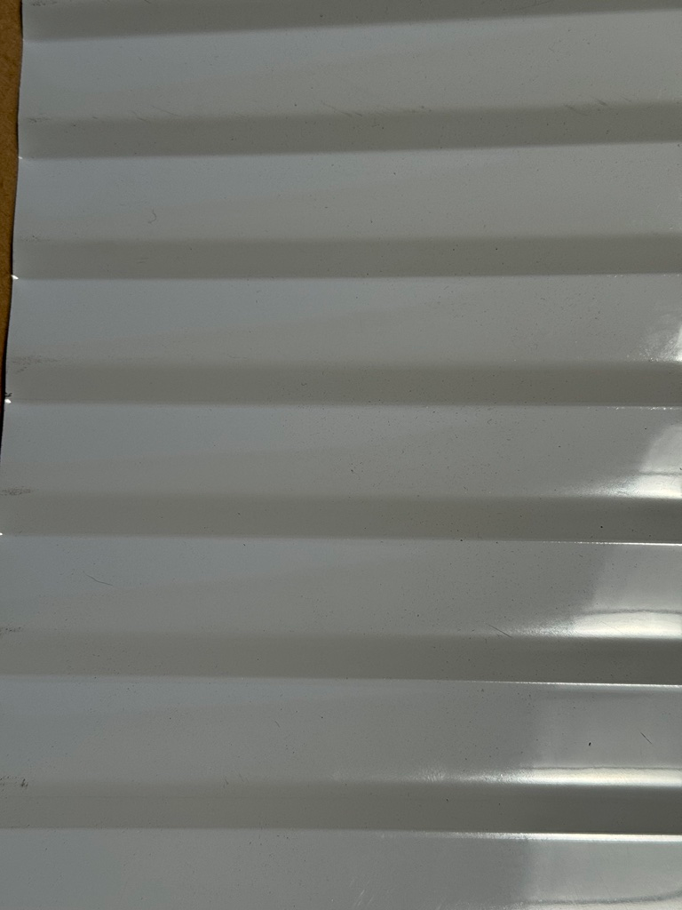 A close up of a white corrugated metal roof.