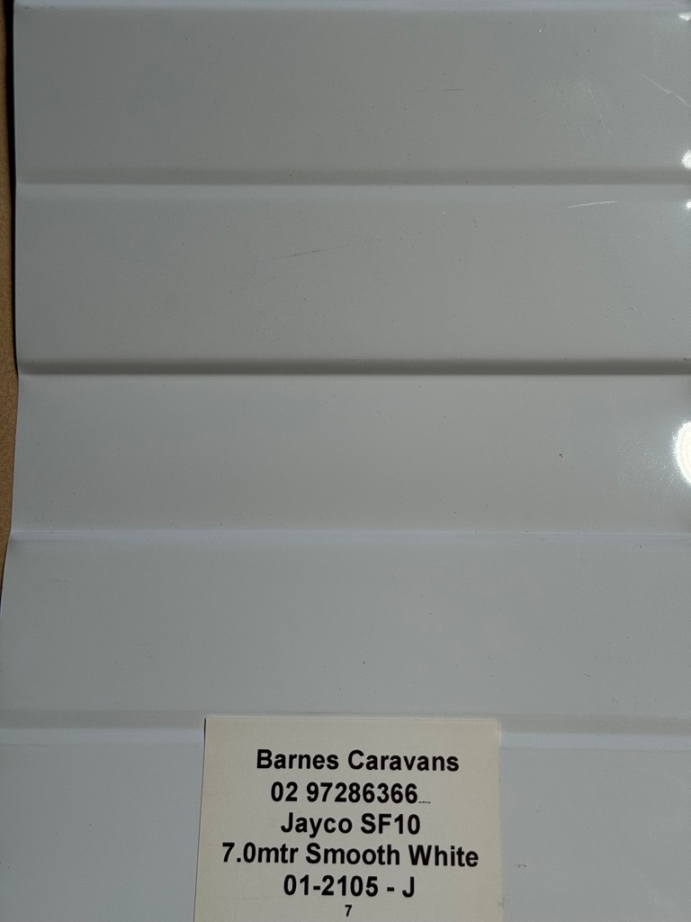 A white item with a label that says barnes caravans